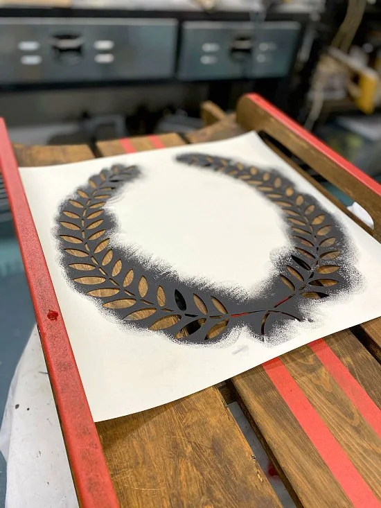 A wreath stenciled wooden sled