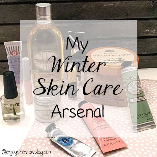 multiple skin care products sitting on a table - infographic overlay with black lettering that says "My Winter Skin Care Arsenal" 