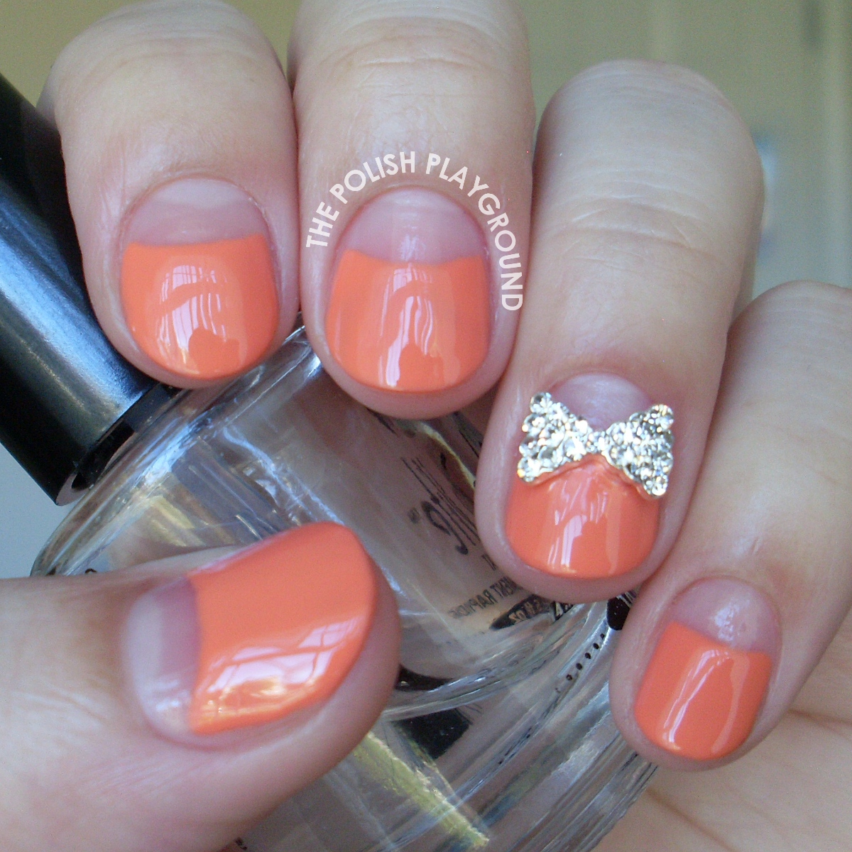 Orange Negative Space Half Moon Manicure with Bow Stud Nail Art