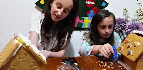 my girls making a gingerbread house