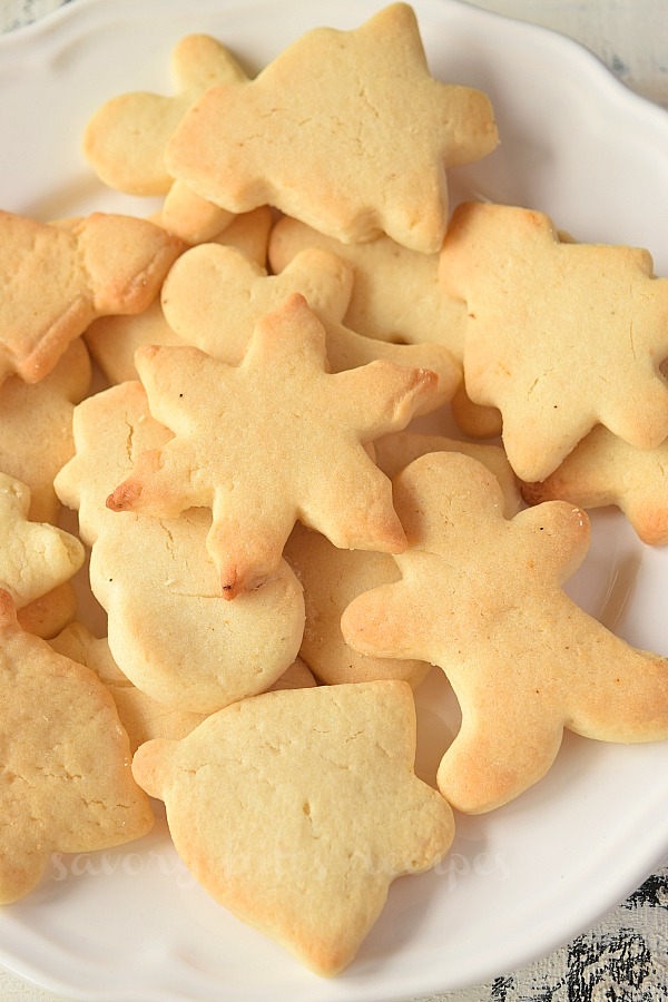 a close up of Christmas sugar cookies on a white plate