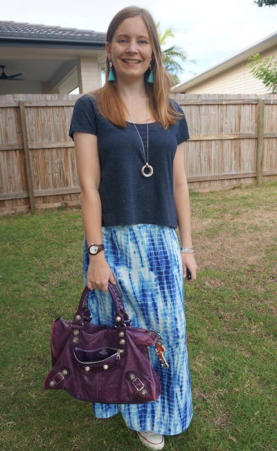 navy tee with blue tie dye maxi skirt and purple balenciaga work bag accessorising monochromatic outfit