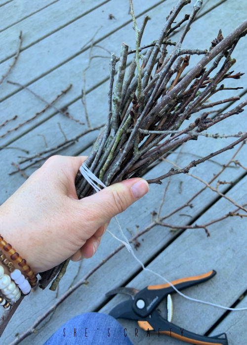 How to make a twig broom for Halloween - gather twigs, wrap twine around