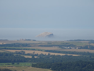 View from Traprain Law over fields in East Lothian to the Bass Rock, which is shrouded is a sea mist.  Picture by Kevin Nosferatu for the Skulferatu Project.