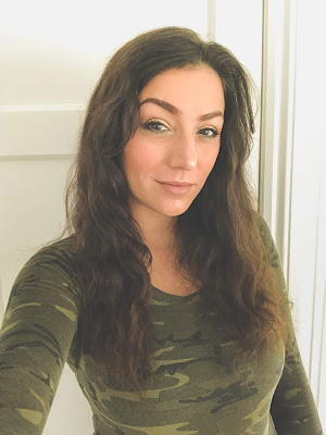 What Cat Says Blog - I Got A New Haircut! A picture of me with my wavy long hair mid way down my chest. I am wearing a camo print bodysuit.This is before I had my haircut.