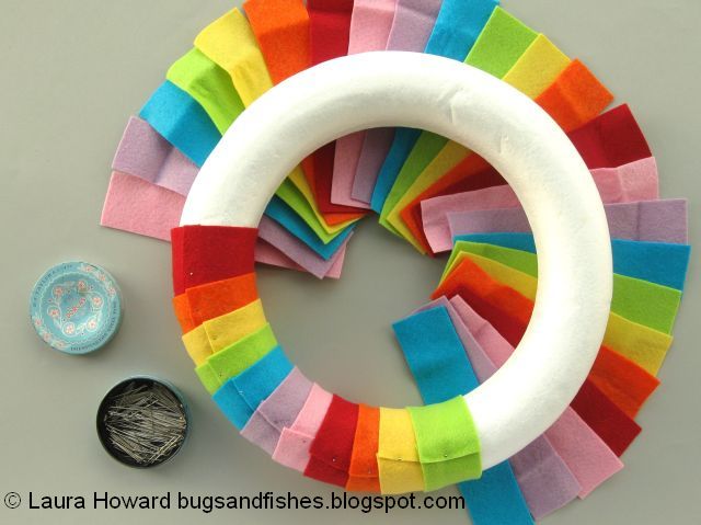DIY January Rainbow Welcome Wreath Tutorial pinning the rainbow felt to the wreath base