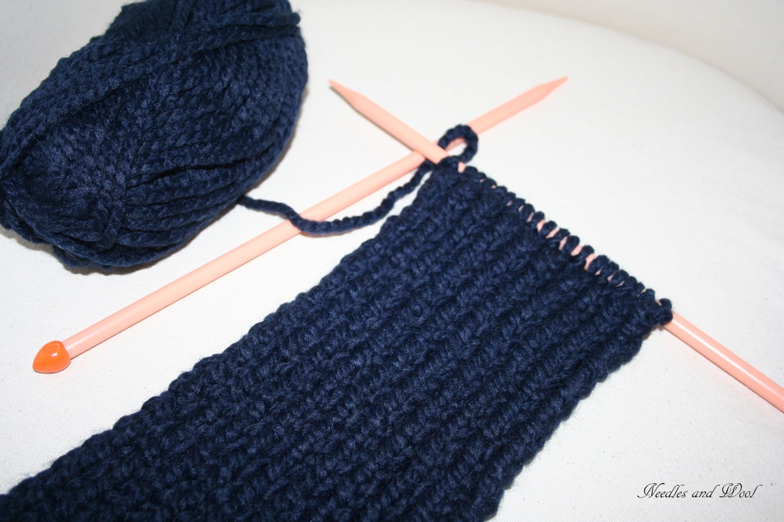 Needles and Wool Knitting a Scarf and Continuing the Sweater