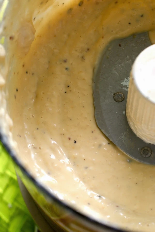 Homemade Creamy Caesar Salad Dressing in a food processor.