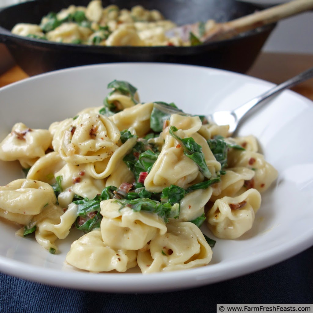 Cheese tortellini with beet greens and bacon.