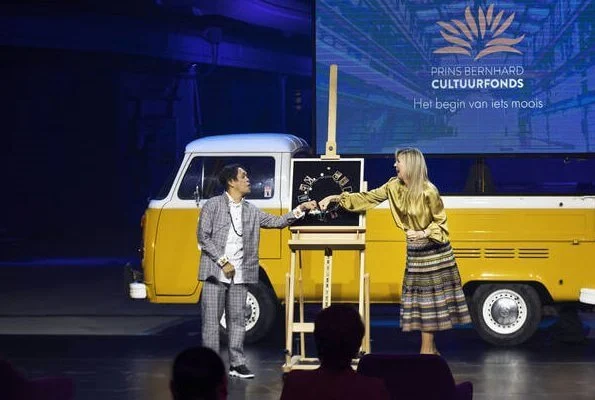 Bernhard Culture Fund Prize 2020. Queen Maxima wore a yellow satin balloon sleeve rounded neckline blouse, and paisley printed midi skirt