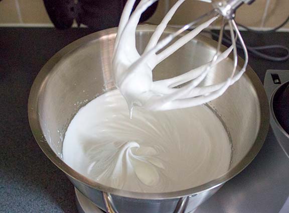Whisking egg whites to make meringue.