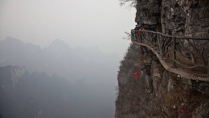 Jutting out from a sheer cliff 1,430 meters high, the glass skywalk in Zhangjiajie National Forest Park offers sightseers terrifying thrills and clear view of the mountains below as they tread nervously across the 60 meter long bridge encircling the vertical cliffs of Tianmen Mountain in Hunan province. The 3ft-wide, 2.5in thick glass walkway is so scary that sightseers are requested to wear cloth slip-ons over their shoes when they cross the skywalk, presumably to make the job easier for the cleaners.