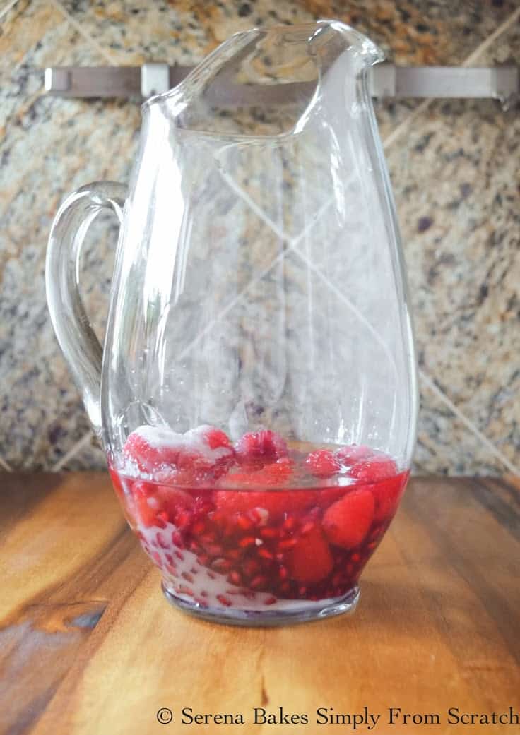 Pitcher with Pomegranate Seeds, Raspberries, White Rum and Sugar.