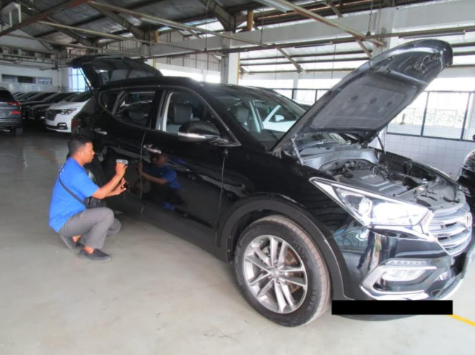 Inspektor dari Otospector tengah menginspeksi mobil bekas Mobil Bekas