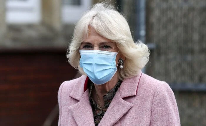 The Duchess met with those involved in the vaccination process, including NHS staff, volunteers and representatives. Pink wool coat and black boot