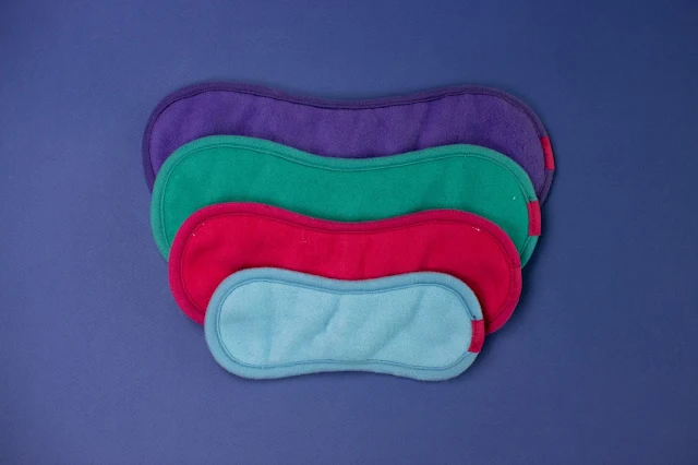 4 reusable sanitary pads lined up to show the varying sizes
