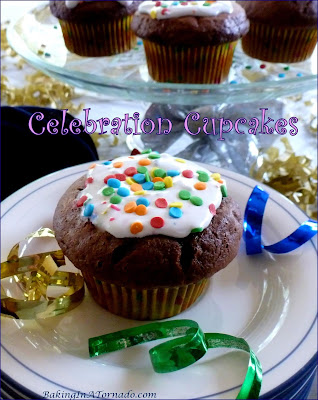 Celebration Cupcakes for the holidays, birthdays, or any celebration. Moist chocolate cupcakes are filled with marshmallow crème and multicolored sprinkles. | Recipe developed by www.BakingInATornado.com | #recipe #cake