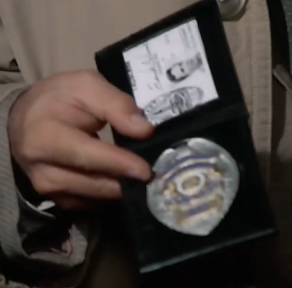 A close-up of Columbo's badge