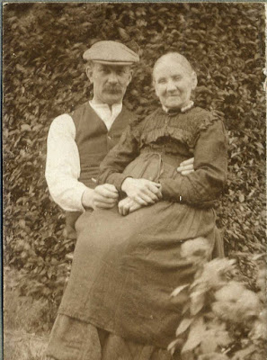 Seated gentleman with older lady on his lap