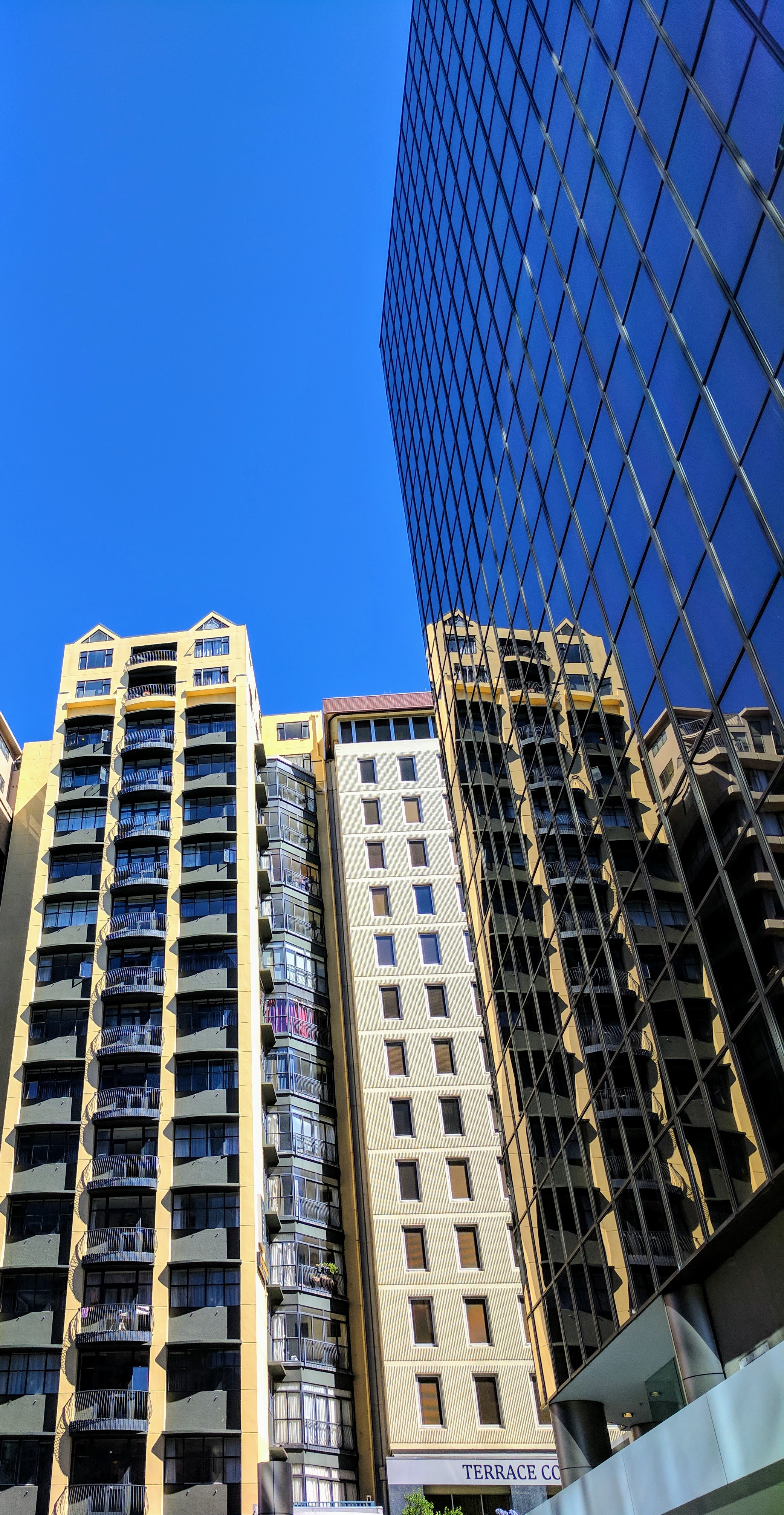 Reflections of CBD and blue sky