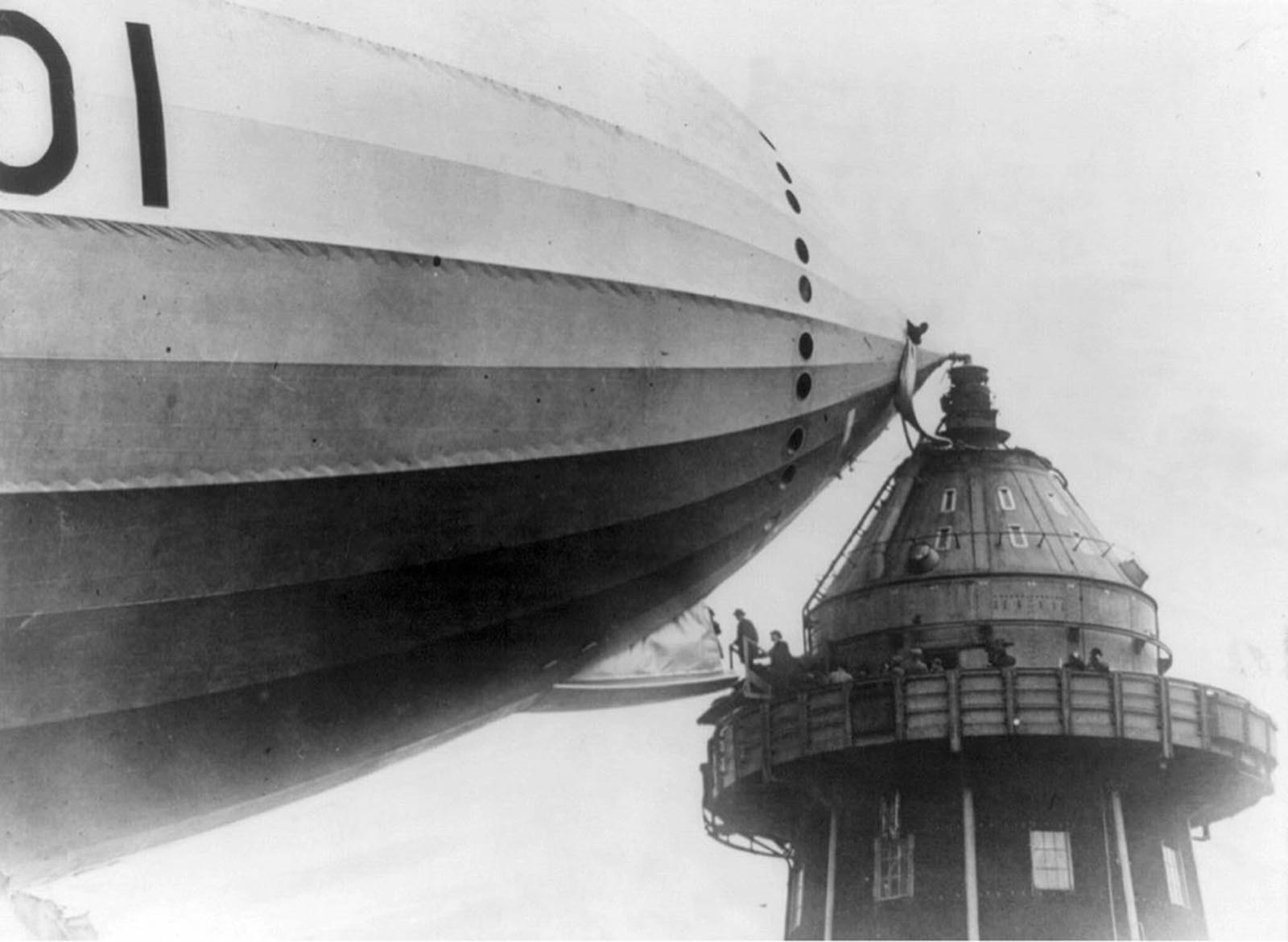 British M.P.s walk onto an airship gangplank, in Cardington, England, in the 1920s.