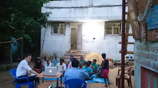 A family and neighbours gather together for a bible message