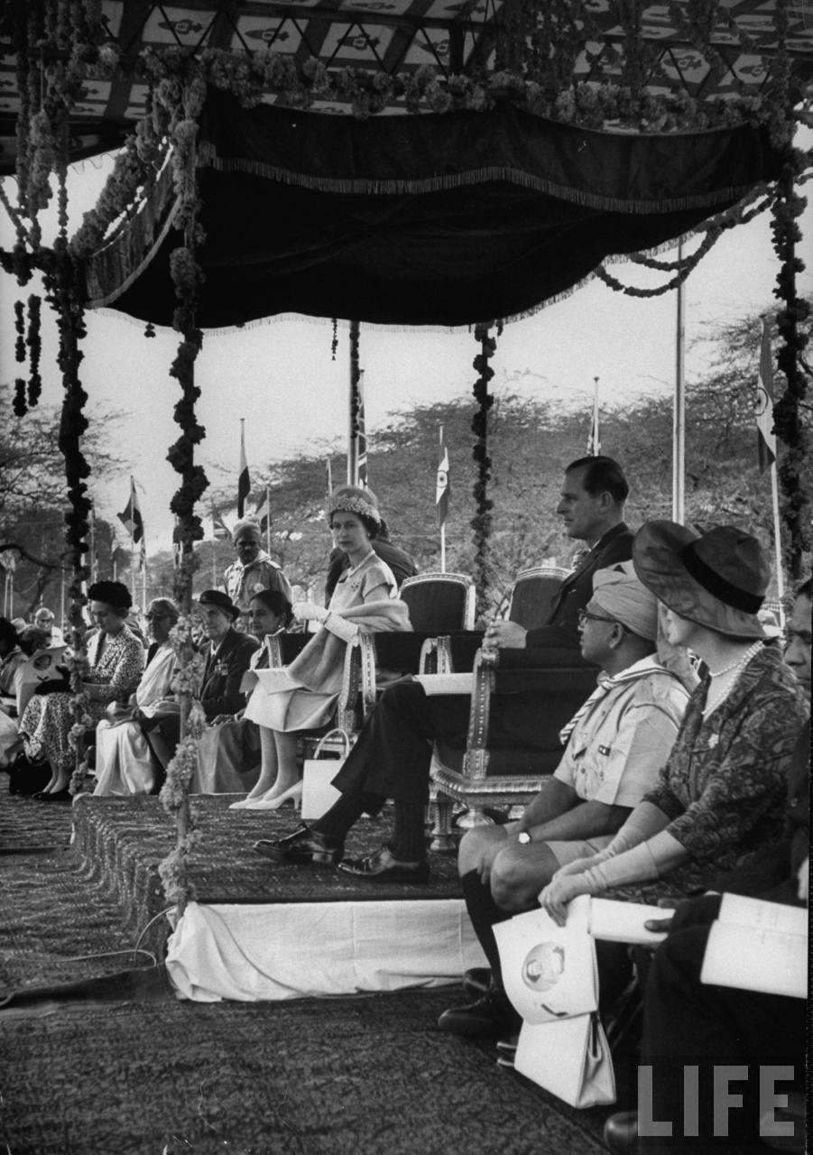 Queen Elizabeth II & Philip attending rally in their honor during their visit to India.