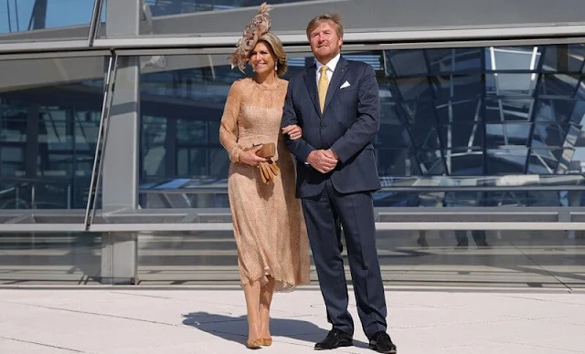 Queen Maxima wore a brown dress from Natan Edouard Vermeulen, and a leaf style hat from Berry Rutjes. Chancellor of Germany Angela Merkel