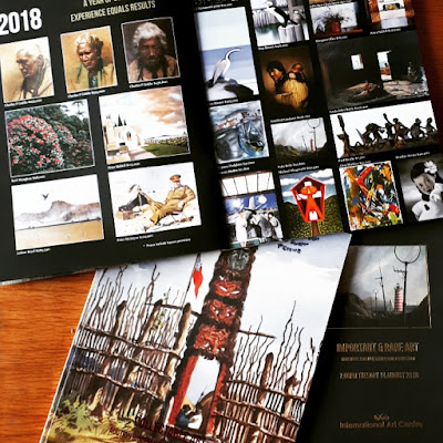 Three art catalogues arranged on a table. The top one is open to show the range of dolls'-house-sized prints included inside.