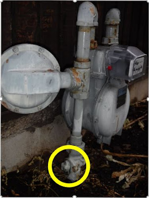 Natural gas meter going into residential home, shut off is highlighted