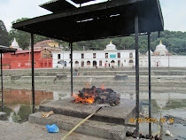Hindu funeral pyre aside the sacred Bagmati River (Kathmandu, Nepal)