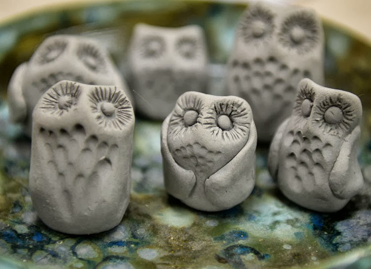 Clay owls waiting to dry and then be fired.