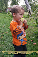 32 month old tastes an apple he holds