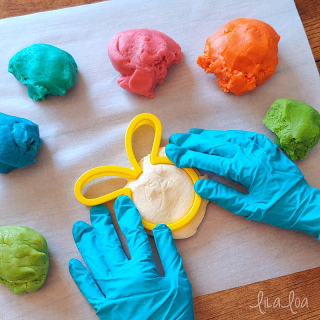 Making an Easter bunny cookie with colored cookie dough.