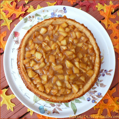 Celebrate apple season with an Apple Pie Cheesecake, apple pie flavored cheesecake with a caramel apple topping. | Recipe developed by www.BakingInATornado.com | #recipe #apple #RoshHashanah