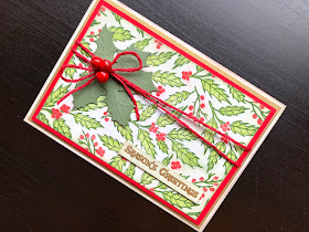 Christmas card with stamped layered holly background, die cut holly leaves and red jingle bells