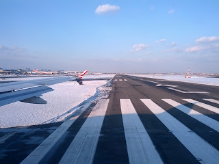 Newark Airport runway 4 bracketed by snow-covered ground.