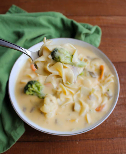 This cheese soup is a copycat recipe my family has enjoyed for years. It is full of vegetables, pasta and creamy cheesy goodness. It's a regional favorite and soon to be a favorite for you as well! spoonful of kelly's cheese soup
