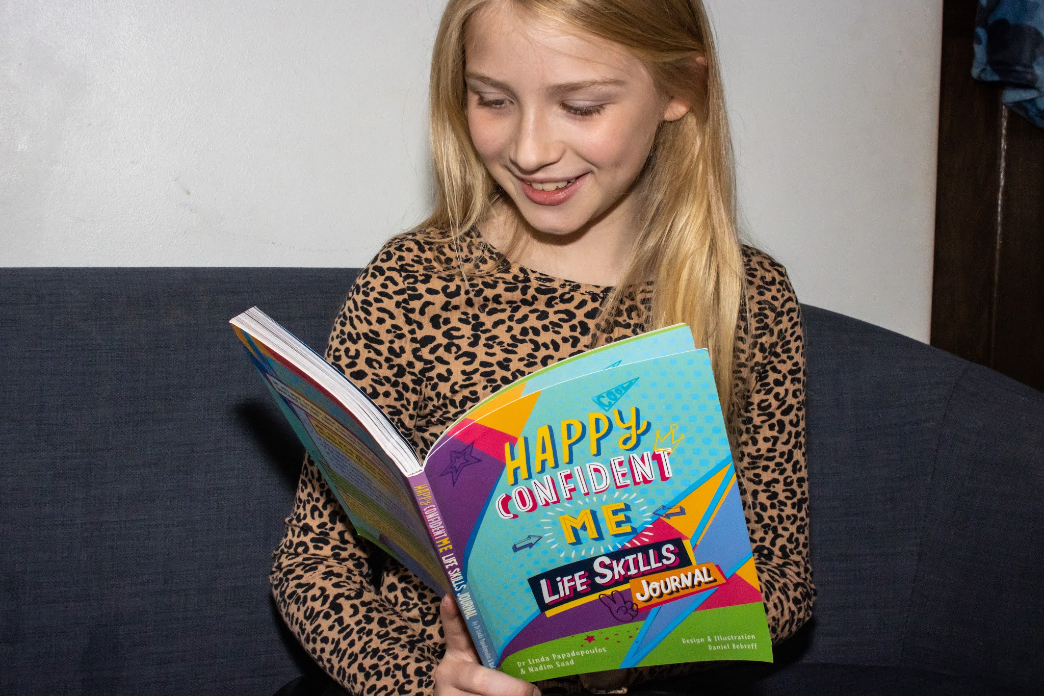 A tween girl reading the Happy Confident Me Life Skills Journal