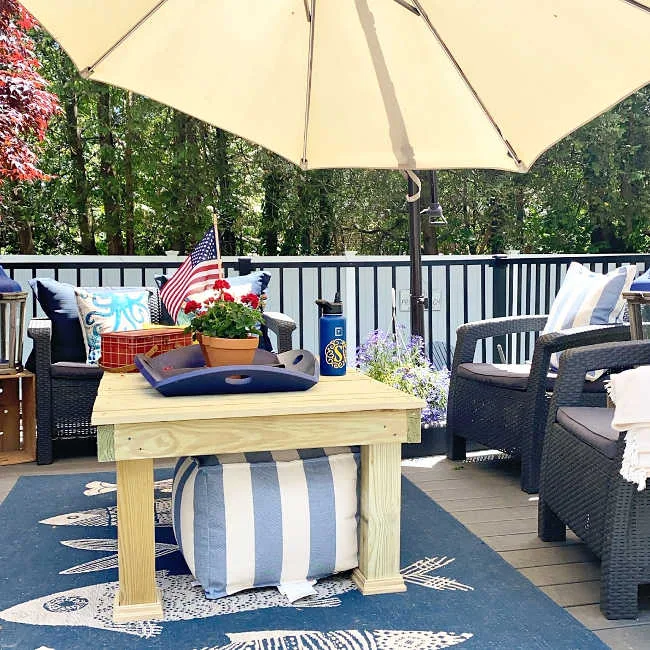 wooden coffee table on a blue fish rug