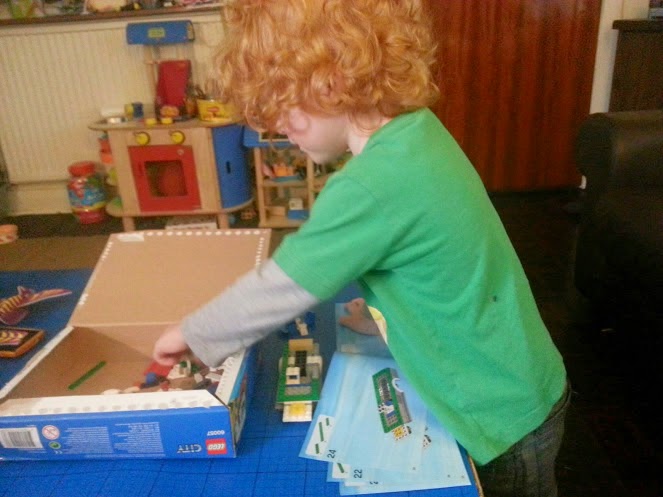 Four year old building LEGO Camper Van set 60057 age 5+