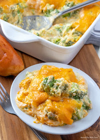 Broccoli Cheese Casserole in white casserole dish and served on a white plate with a serving of bread