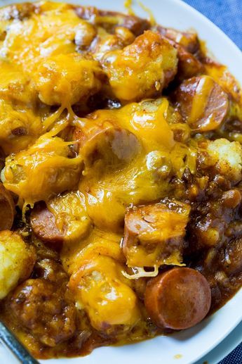 Cheesy Hot Dog Tater Tot Casserole is pure comfort food. Sliced hot dogs, chili, tater tots, and cheddar cheese combine to make an easy and delicious meal. This redneck casserole is sure to be a family favorite.