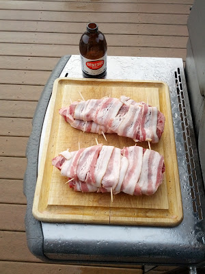 Preparing the bacon wrapped steaks for cooking.