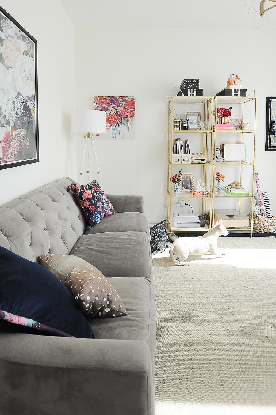 A small sofa serves as seating in this bright white and gold home office makeover.