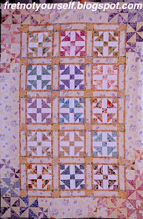 Pastel fabrics in yellow, blue, green and pink are used to make this Grandmother's Dream quilt.