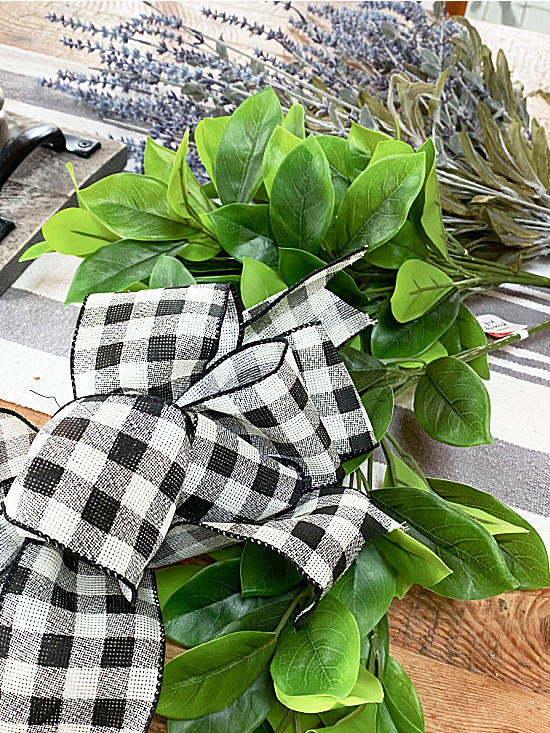 greenery and a black and white bow