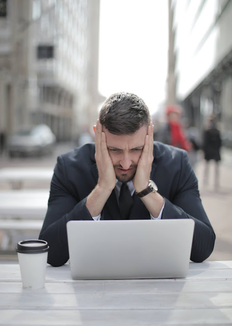 A stressed out man undergoing dissatisfaction in the workplace.