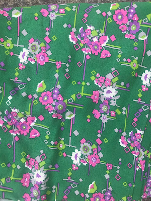 Vivid green fabric with bright pink flowers on. It's very clashy and possibly quite tasteless.