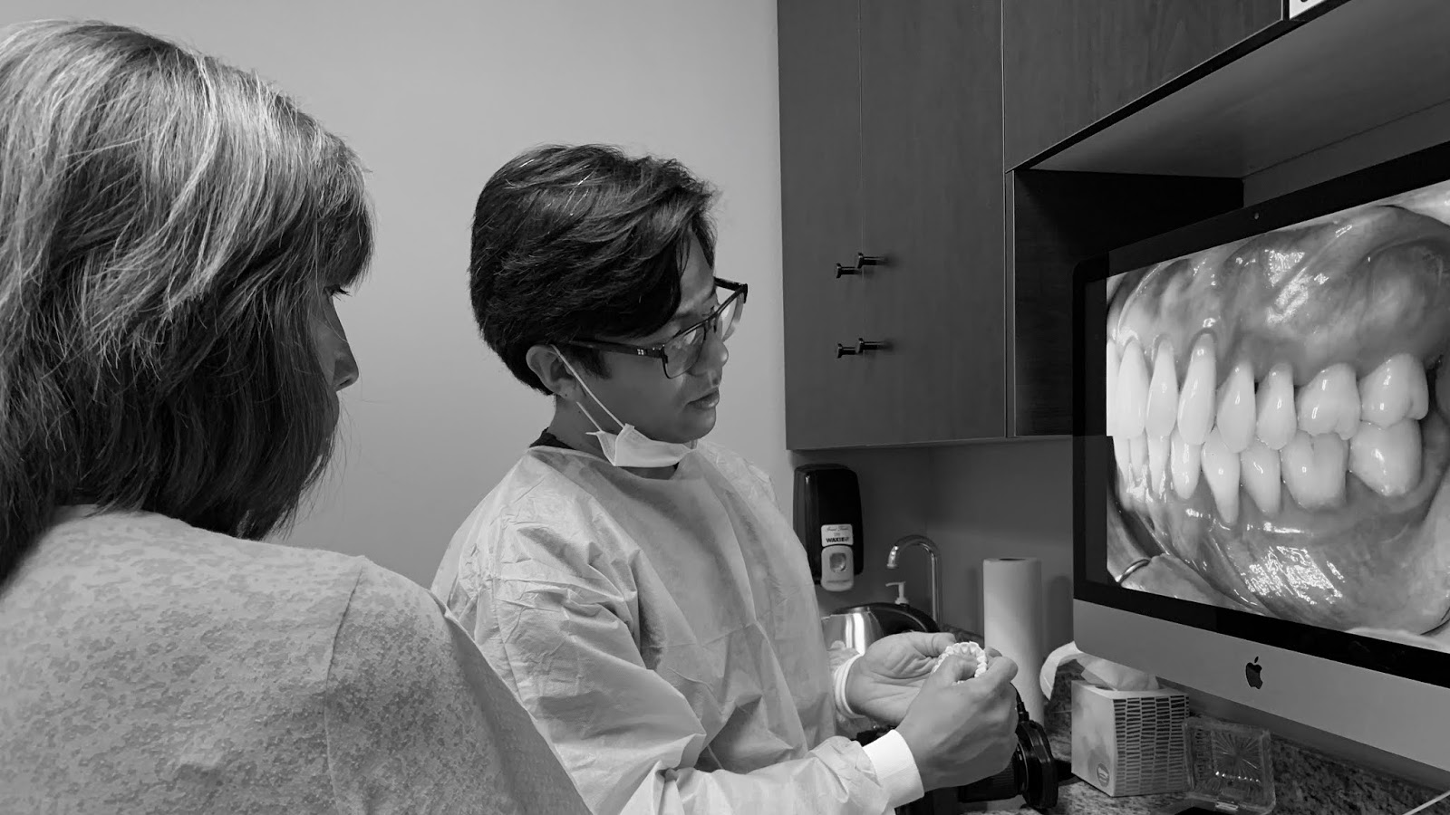 Dr. Do educating a patient on the condition of her mouth
